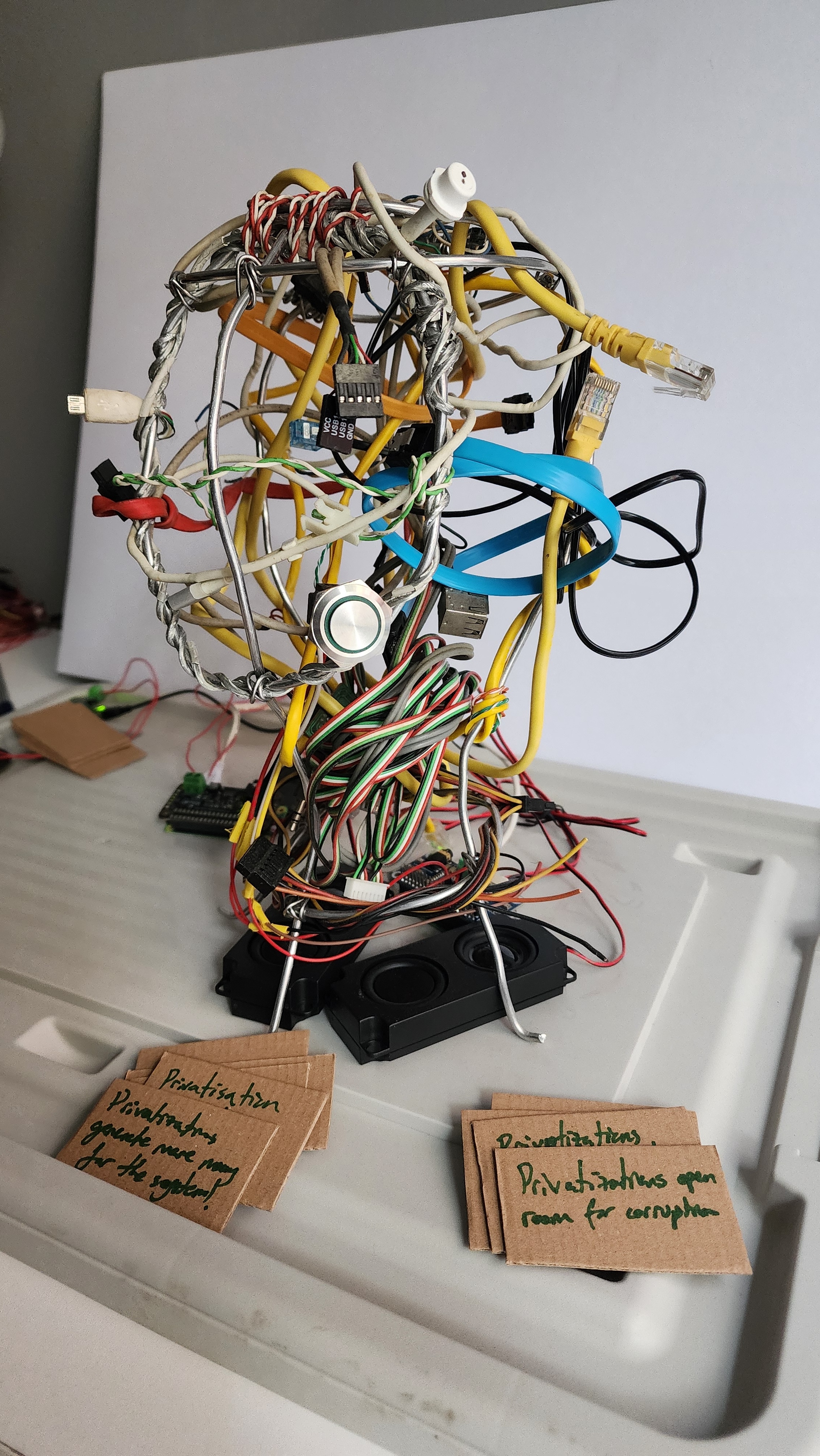Three sculptural wire heads made from reclaimed communication cables